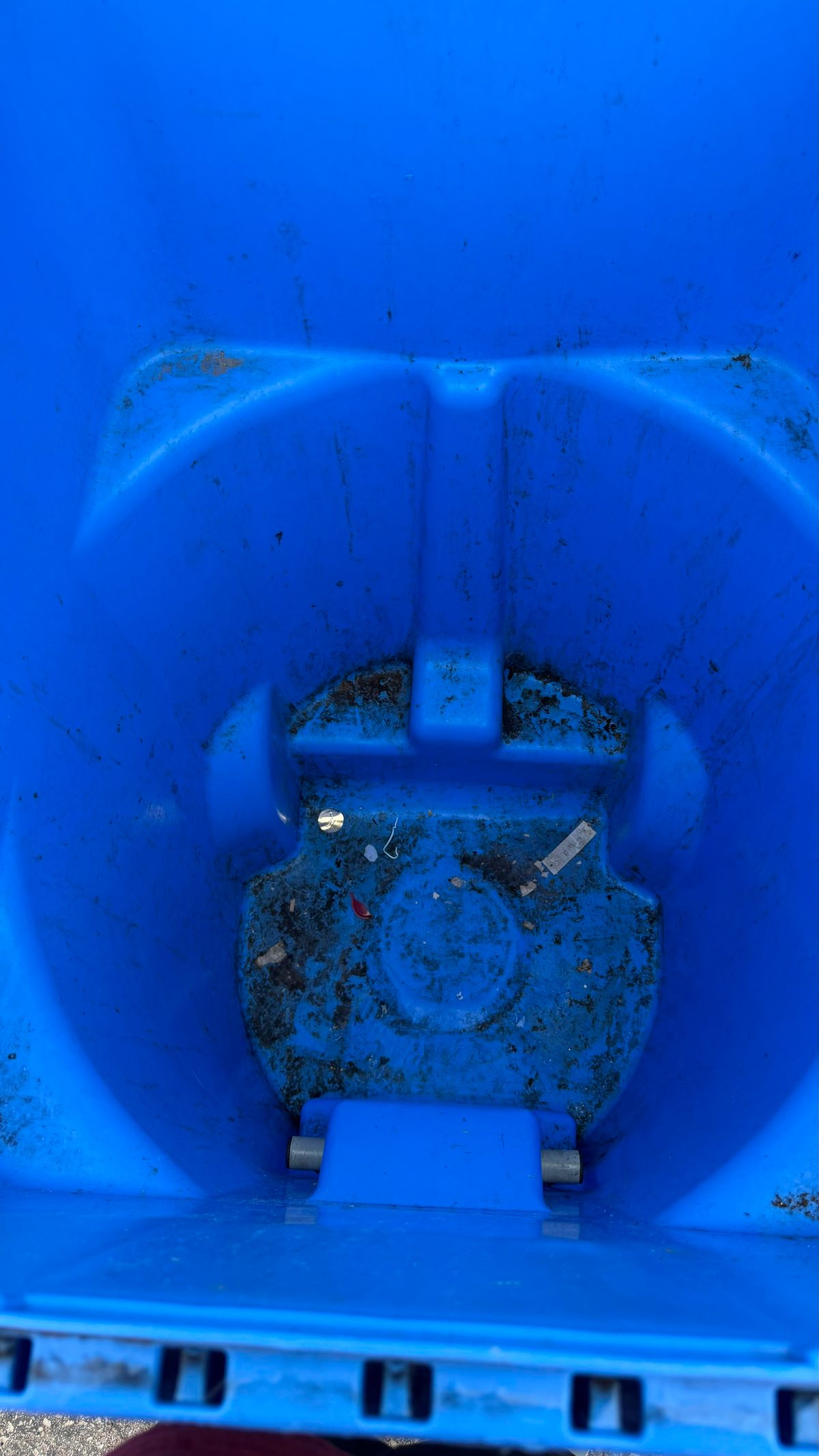 Blue bin with heavy buildup before professional cleaning