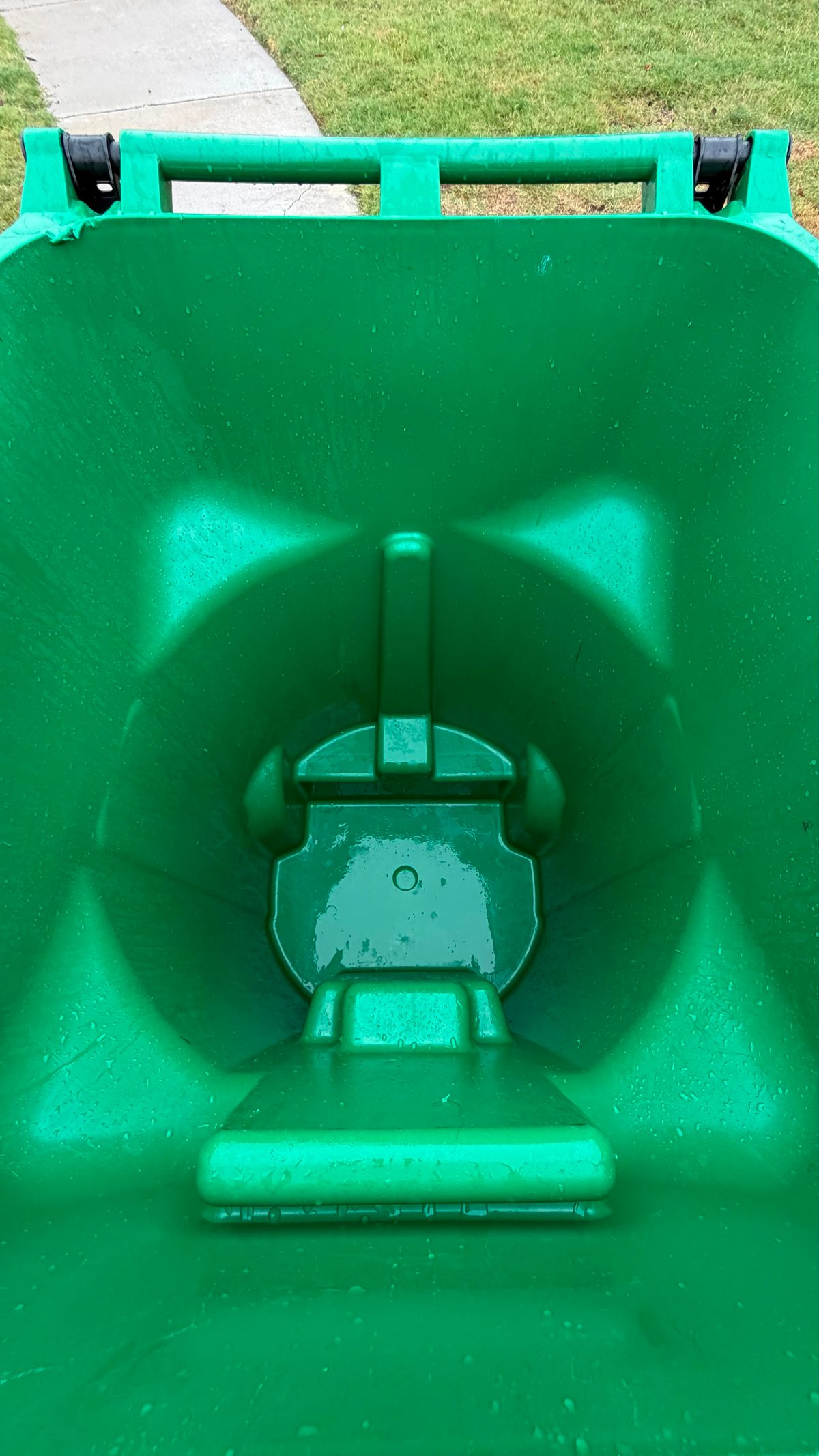 Green trash bin spotless after hot-water pressure washing up to 250&deg;F